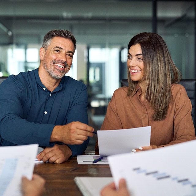 Couple at business meeting reviewing investment contract